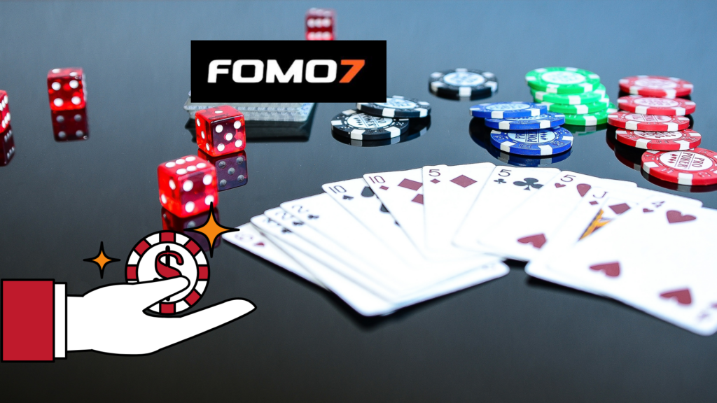 A gaming setup featuring poker cards, colorful casino chips, red dice, and the FOMO7 logo on a reflective black surface, with an illustrated hand holding a casino chip.